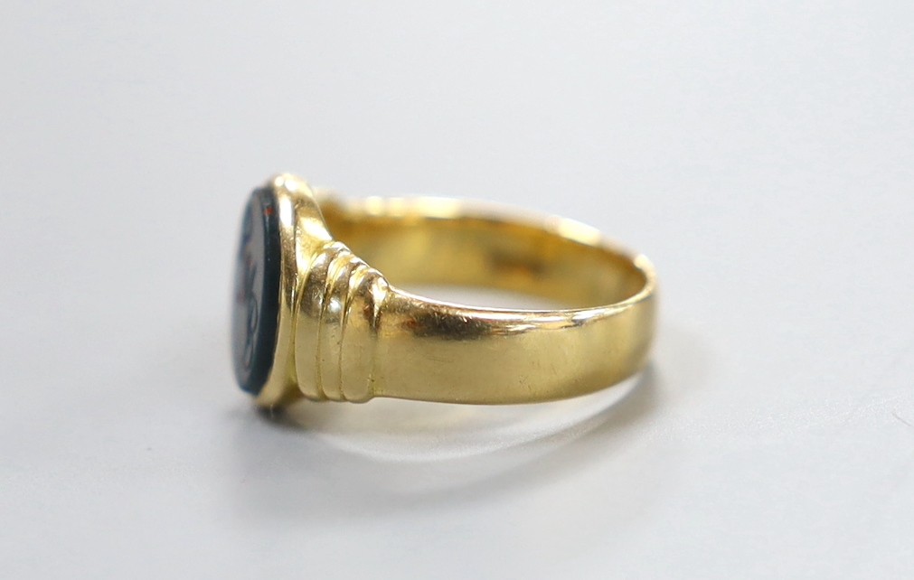 A George V 18ct gold and bloodstone set signet ring, the stone with engraved initials, size M, gross 6.3 grams.